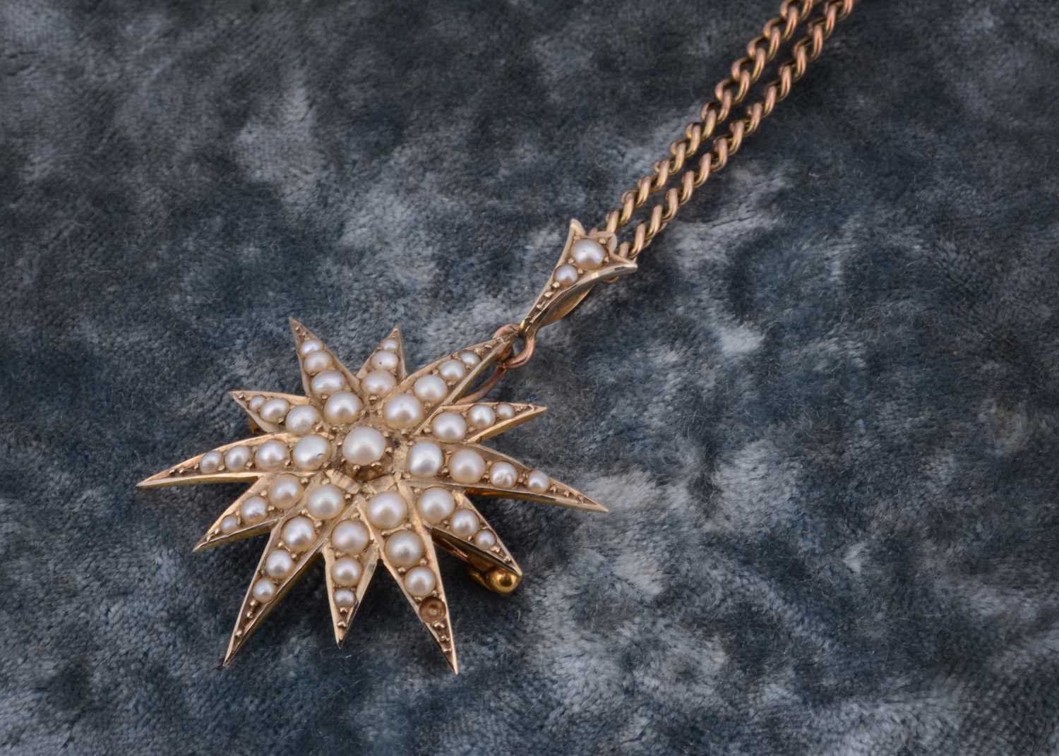 Lot 52 - An Edwardian 9ct gold seed pearl star drop pendant and brooch