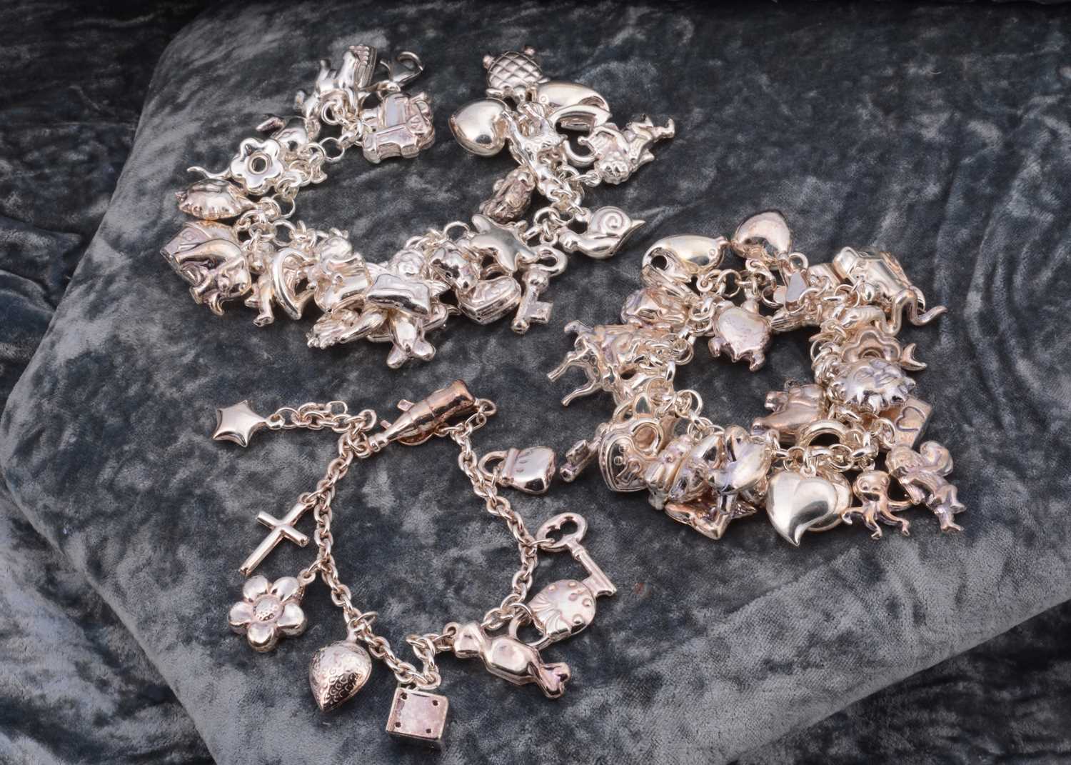 Lot 57 - Three silver charm bracelets