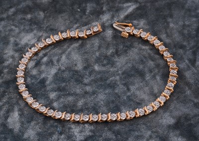 Lot 60 - A 9ct gold diamond set line bracelet
