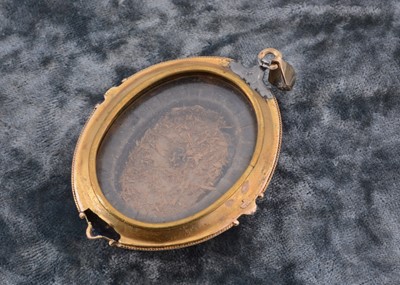 Lot 71 - A 19th Century oval yellow metal enamel and onyx drop pendant