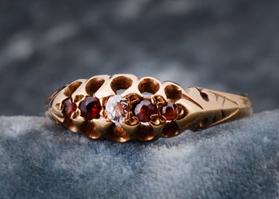 Lot 99 - A garnet and diamond set dress ring