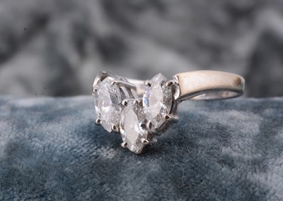 Lot 126 - A three stone 18ct white gold diamond set wishbone dress ring