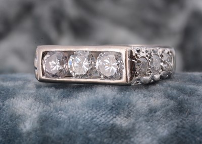 Lot 128 - A three stone diamond set 18ct white gold lady's dress ring