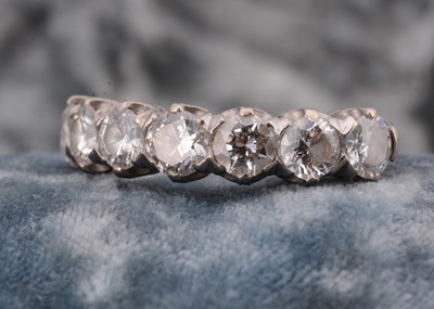 Lot 135 - An 18ct gold diamond half hoop eternity ring
