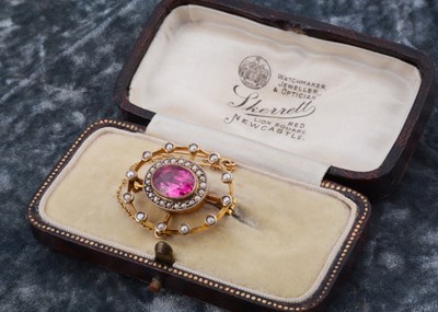 Lot 139 - An Edwardian seed pearl and synthetic ruby oval brooch, of pierced design