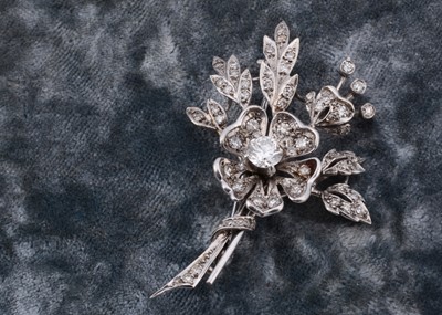 Lot 144 - A 9ct white gold floral diamond set spray brooch