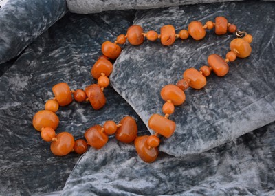 Lot 161 - A string of boulder butterscotch amber beads