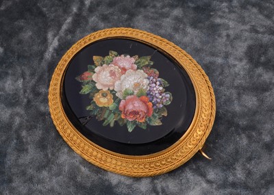 Lot 210 - A 19th century oval pietra dura floral decorated oval brooch