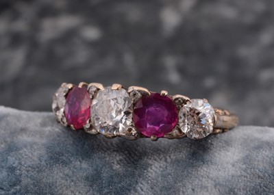 Lot 218 - An early 20th century five stone ruby and diamond ring.