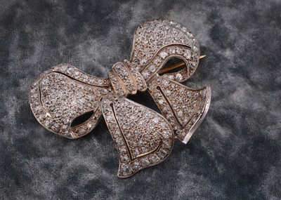 Lot 220 - An Art Deco gold and platinum diamond set bow brooch