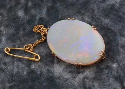 Lot 276 - A precious opal and gold oval brooch