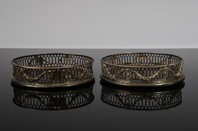 Lot 341 - A pair of George III silver and wooden wine bottle coasters