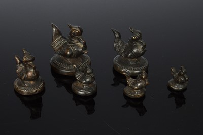 Lot 412 - A set of six bronzed opium weights