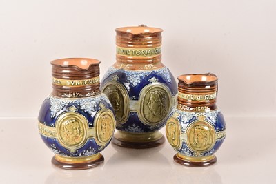 Lot 157 - A set of three graduated Doulton Lambeth Queen Victoria Diamond Jubilee stoneware jugs