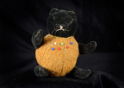 Lot 129 - An unusual 1920s British black velvet cat pumpkin pin cushion