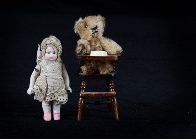 Lot 144 - A post-war Schuco miniature teddy bear and bisque dolls’ house doll