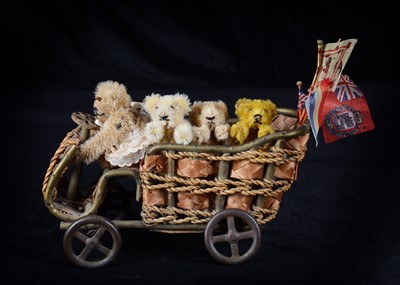 Lot 145 - A wicker display car with four miniature teddy bears