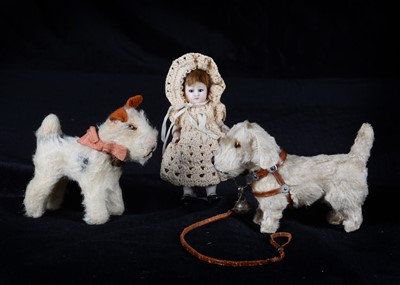 Lot 146 - A German all-bisque dolls’ house doll and two dogs