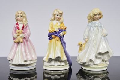 Lot 92 - A collection of three Royal Daulton NSPCC figurines