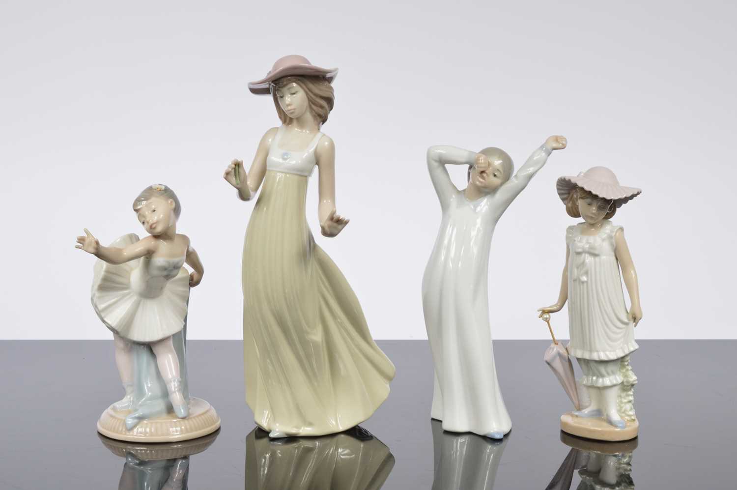 Lot 96 - A collection of four modern NAO porcelain figures