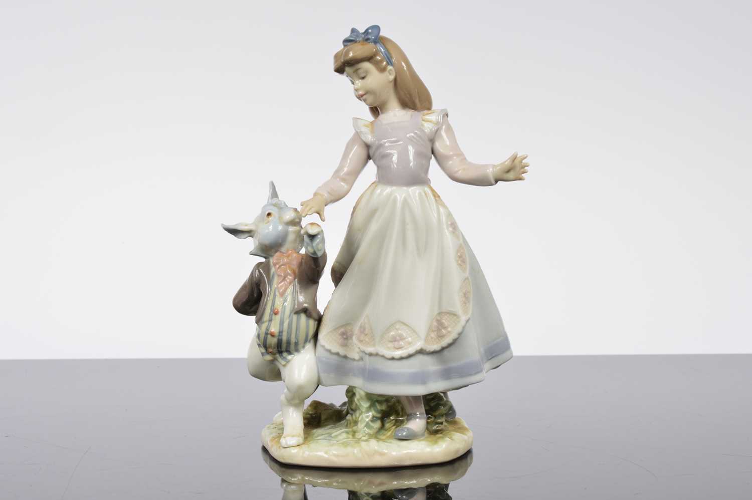 Lot 97 - A Lladro porcelain Alice in Wonderland figural group