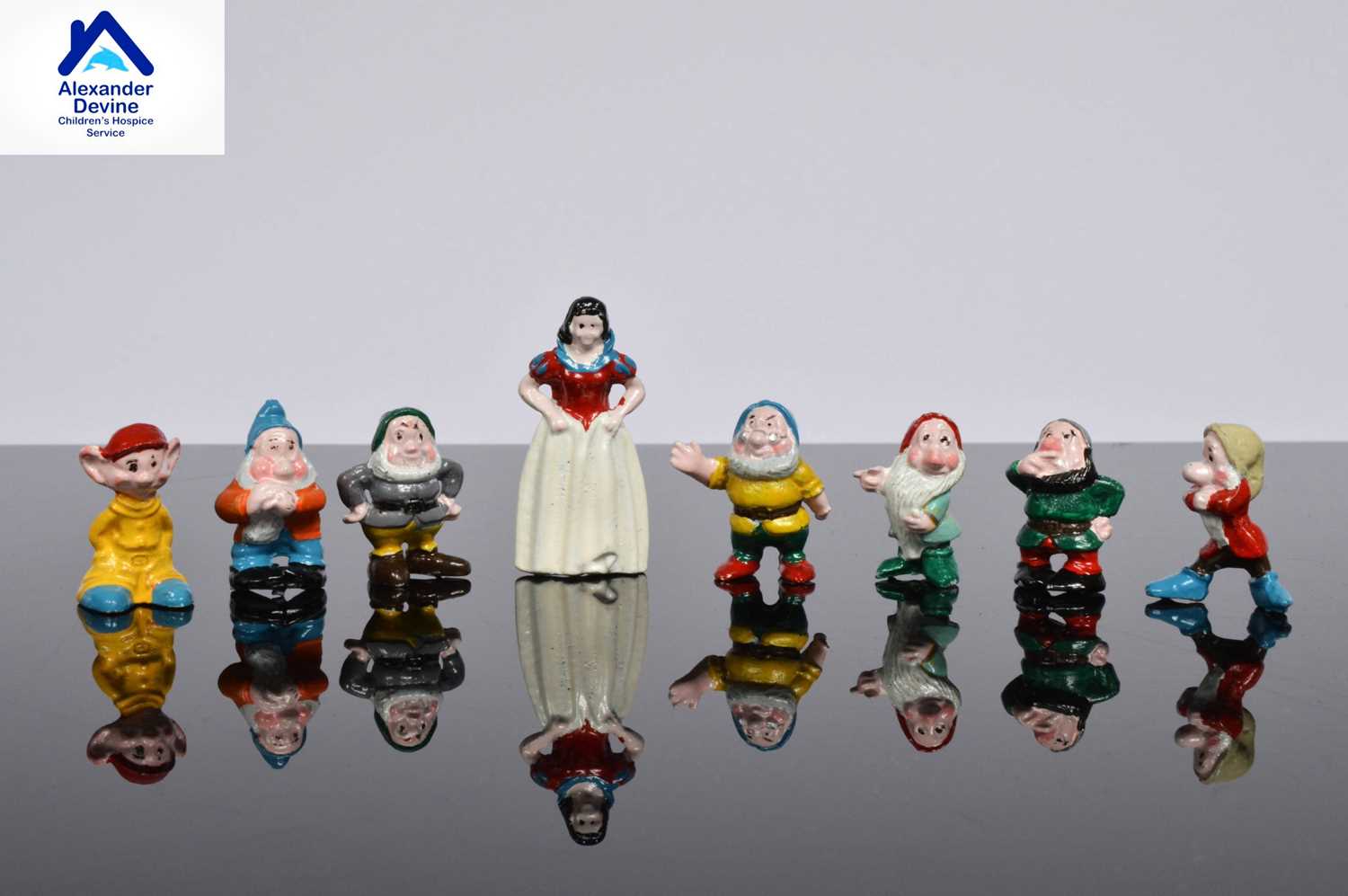 Lot 101 - A set of Snow white and the Seven Dwarfs ceramic miniature figures