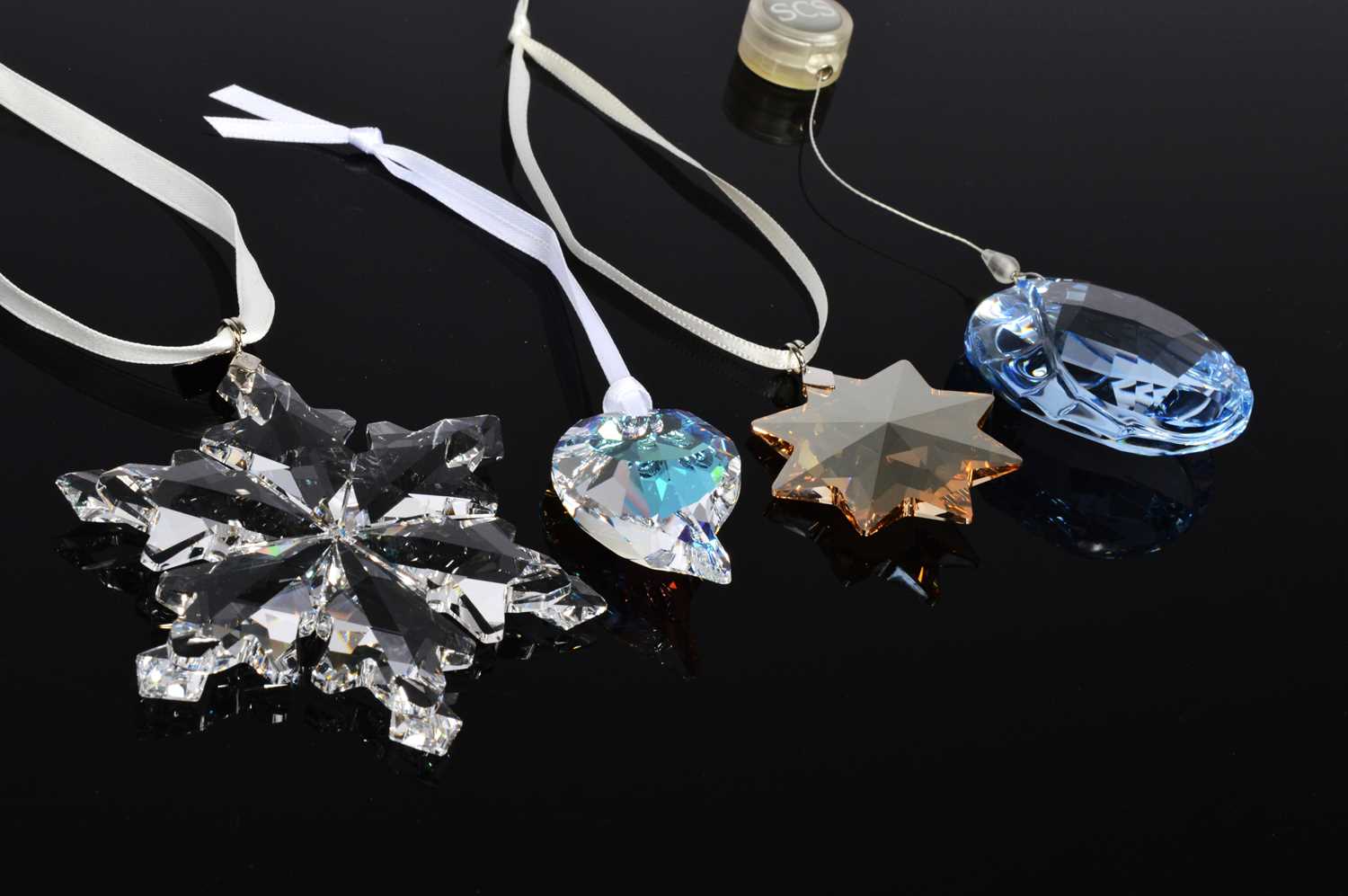 Lot 117 - Four Swarovski Christmas tree ornaments