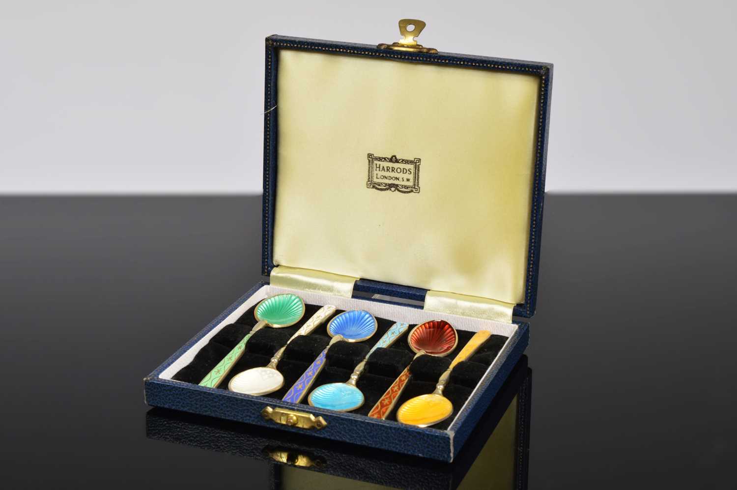 Lot 171 - A set of six enamel and silver Coffee spoons