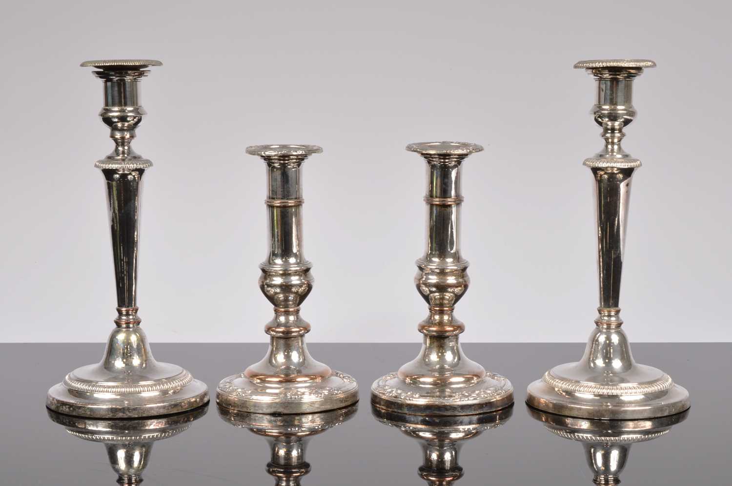Lot 177 - Four silver plated candle sticks