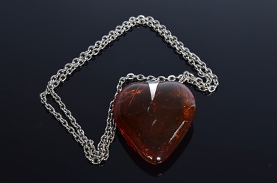 Lot 203 - A polished continental amber heart pendant