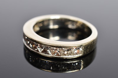 Lot 208 - A white 18ct gold channel set half hoop eternity ring