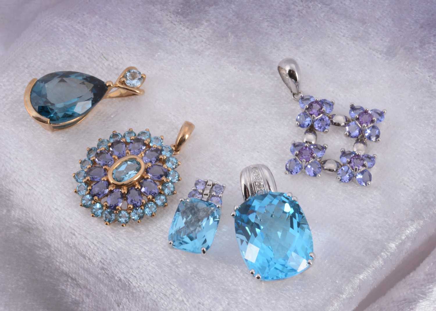 Lot 9 - A collection of topaz and tanzanite 9ct gold pendants