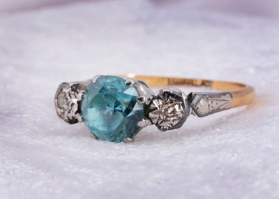 Lot 10 - An 18ct gold and platinum zircon and diamond three stone dress ring