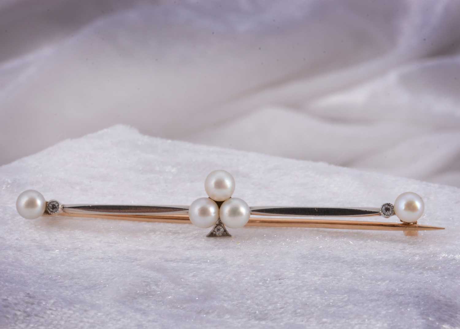 Lot 13 - An Edwardian gold and platinum pearl and diamond bar brooch