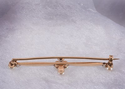 Lot 13 - An Edwardian gold and platinum pearl and diamond bar brooch