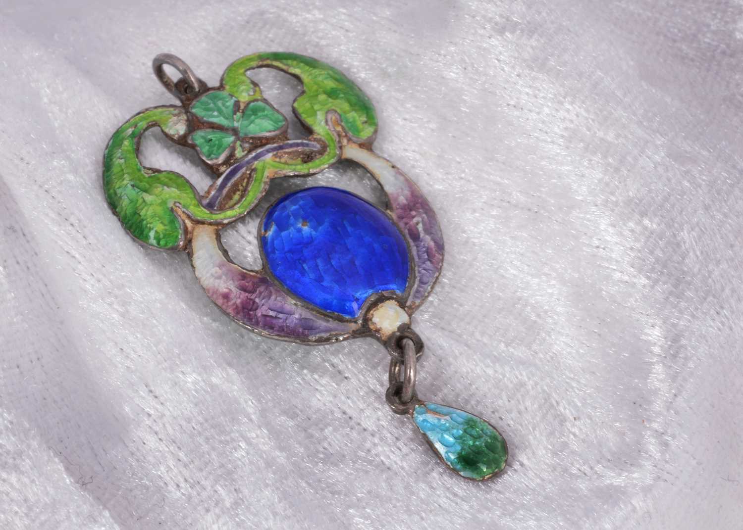 Lot 46 - An arts and crafts silver and enamel clover decorated pendant