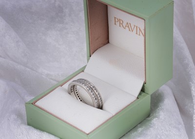 Lot 48 - A pair of platinum Pravins diamond set eternity bands