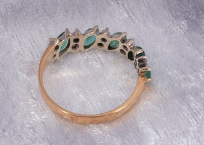 Lot 51 - A 9ct gold emerald and diamond half hoop dress ring