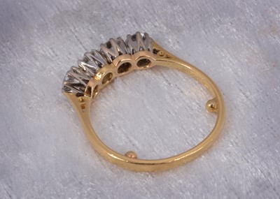 Lot 52 - An 18ct gold four stone diamond dress ring