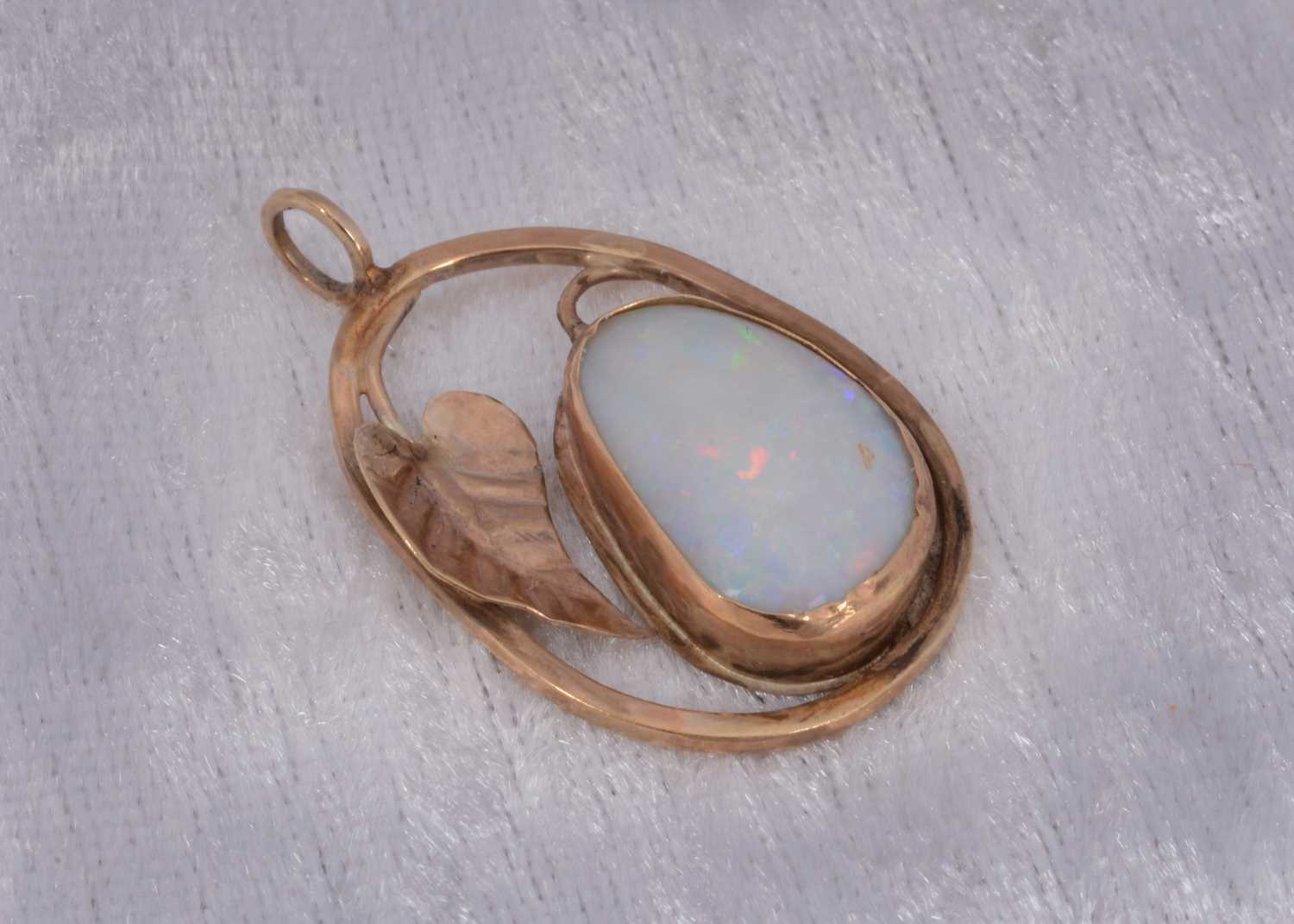 Lot 55 - A 9ct gold opal set ovoid pendant