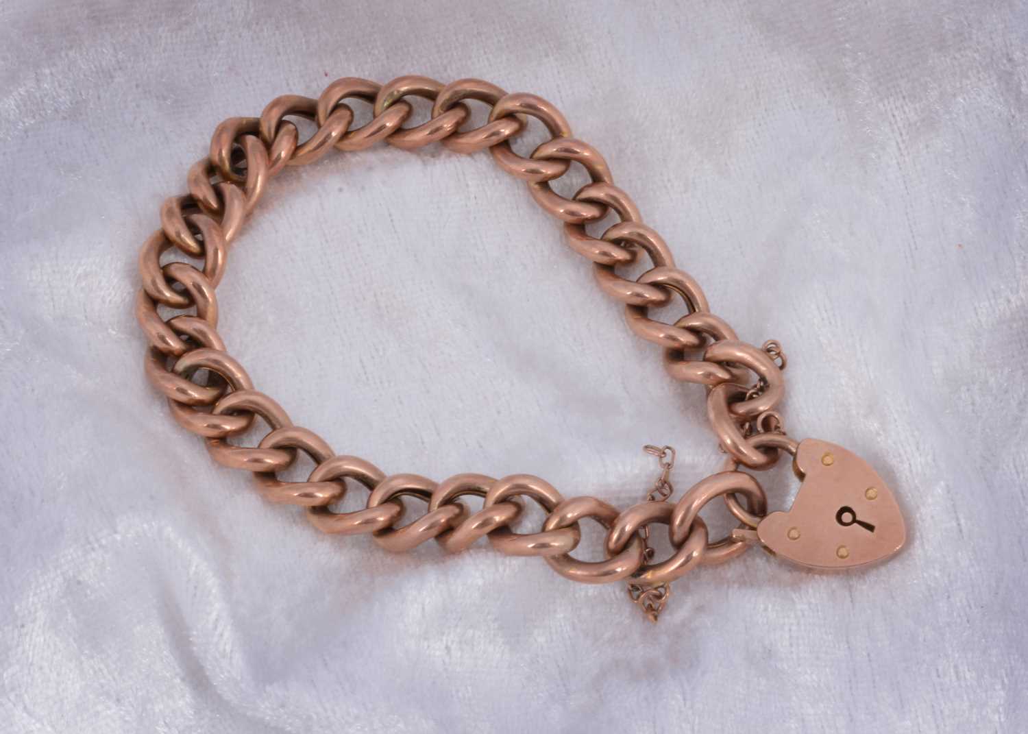 Lot 63 - A 9ct rose gold curb link bracelet.