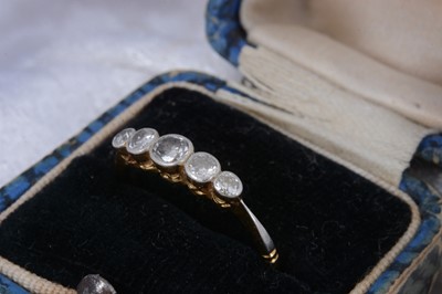 Lot 64 - A five stone 18ct gold diamond dress ring