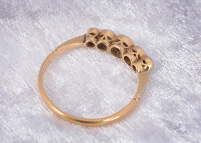 Lot 64 - A five stone 18ct gold diamond dress ring