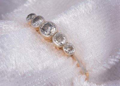 Lot 64 - A five stone 18ct gold diamond dress ring