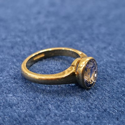 Lot 87 - An 18ct gold single sapphire set dress ring