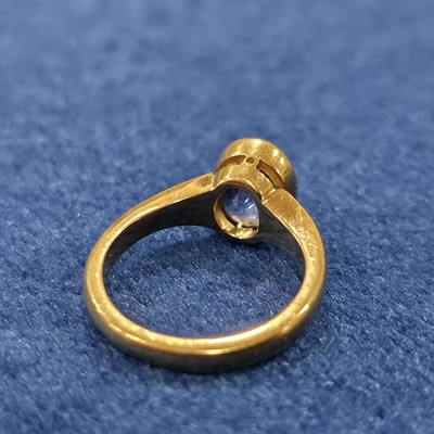 Lot 87 - An 18ct gold single sapphire set dress ring