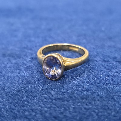 Lot 87 - An 18ct gold single sapphire set dress ring
