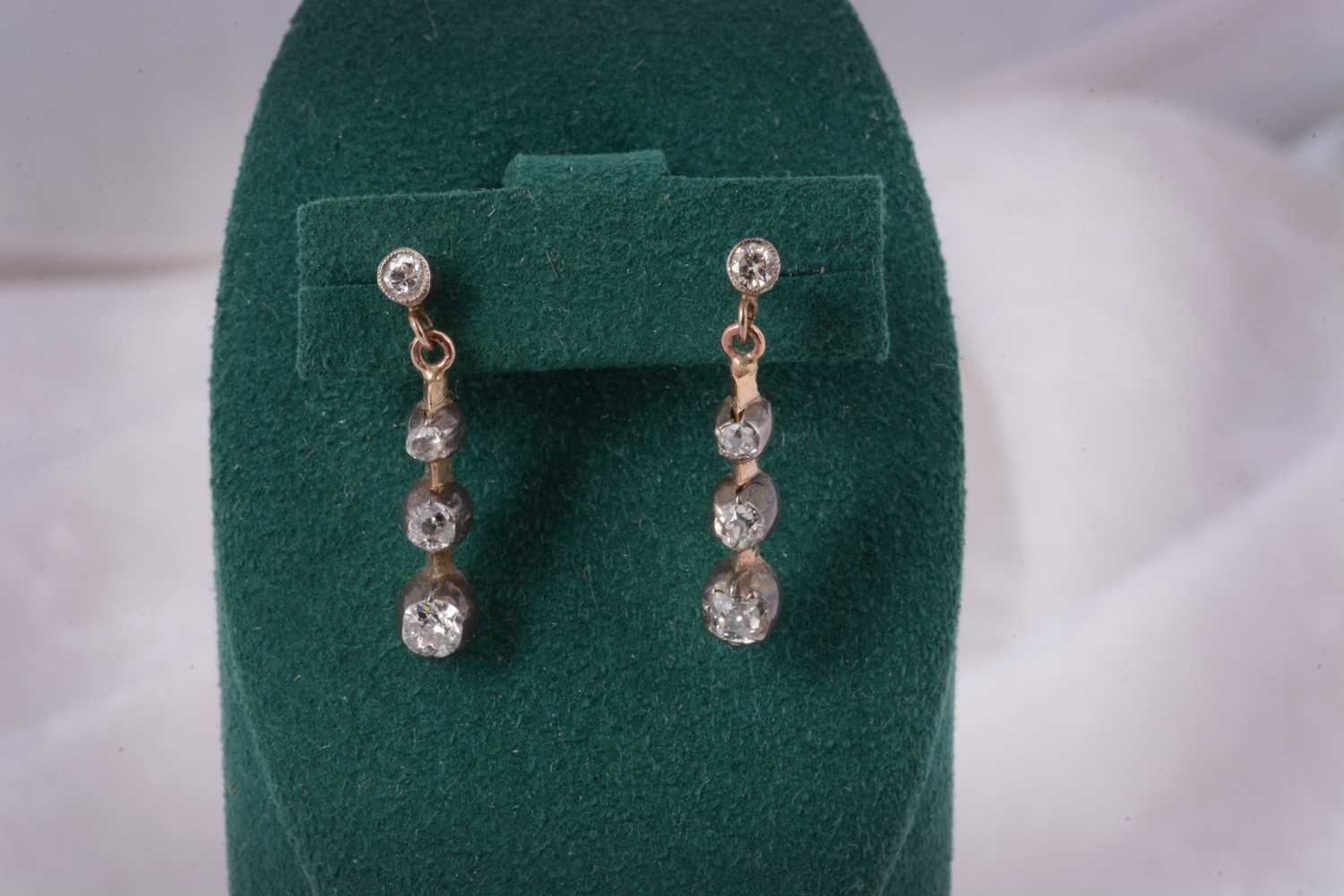 Lot 90 - A pair of Edwardian diamond stud and three drop earrings