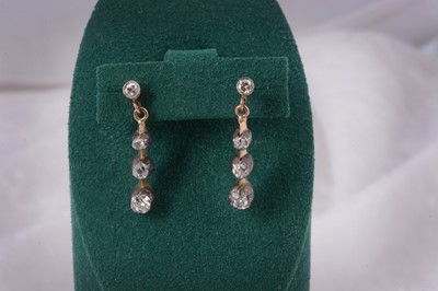 Lot 90 - A pair of Edwardian diamond stud and three drop earrings