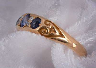 Lot 93 - An 18ct gold three stone sapphire and diamond dress ring